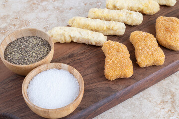Sausage and chicken nuggets isolated on marble background