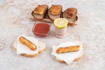 Chicken nugget and sausage sandwiches with lemon and ketchup