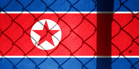 Backlight Backlight with physical North Korean flag and barbed wire. Prison concept with border...