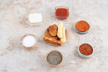 Cheese nuggets and grilled sausages with sauces