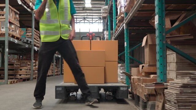 Selective focus of asian exhausted young man in warehouse get tired during work sitting and blow the air for breathing, worried unhealthy worker alcoholism lean on floor take a break while working.
