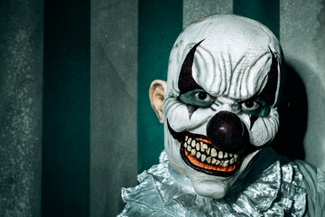 creepy evil clown in an old circus