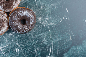 Yummy chocolate doughnuts on blue background