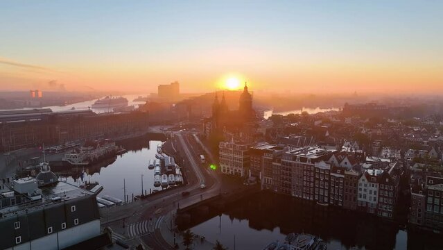 Aerial view of famous places Amsterdam, Netherlands. View of canal and old centre district. railway station Amsterdam Centraal view at sunrise
