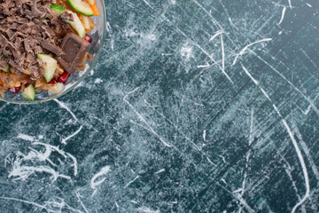 Fruit salad with chopped chocolate on the top