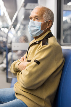 Portrait Of Adult Man In Disposable Mask Traveling In Subway Train During Daily. Concept Of Precautions During Public Transport Use In COVID 19