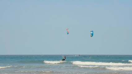 Kite surfing or windsurfing on blue sea water