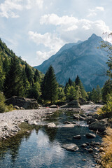 Fototapeta na wymiar River flowing in Val Di Mello, Sondrio, in Lombardy, Italy