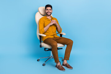 Full size photo of positive nice person sit chair toothy smile isolated on blue color background