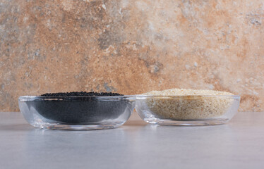 Sesame and black cumin in glass cups