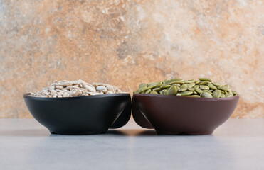 Sunflower seeds and green pumpkin seeds in a platter