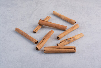 Cinnamon sticks isolated on concrete background