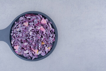 Salad with chopped and minced purple onion and cabbage