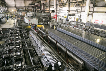 Plant for the production of metal pipes. Workshop with mechanical tools and equipment, rolls of...