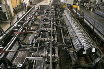 Plant for the production of metal pipes. Workshop with mechanical tools and equipment, rolls of...