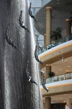 Vertical Shot Of The Dubai Mall Waterfall In Dubai, The UAE