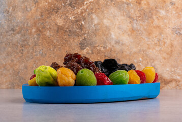 Colored dried cherries and fruits on concrete background