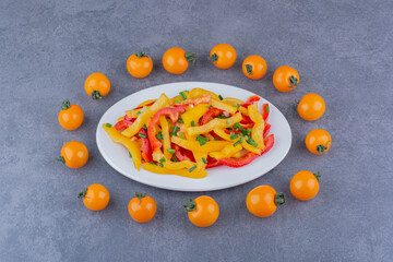 Colorful bell pepper salad with cherry tomatoes on blue background
