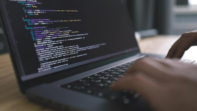 Close up view of laptop screen with code writing, programmer coding software in office