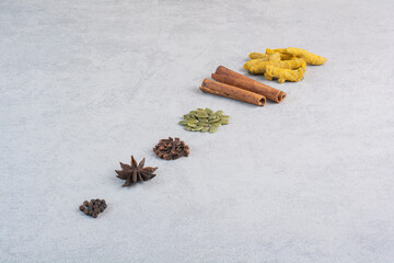 Variety of spices and herbs isolated on concrete background