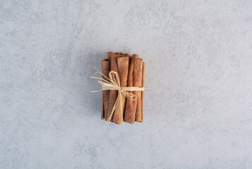 Cinnamon sticks isolated on concrete background