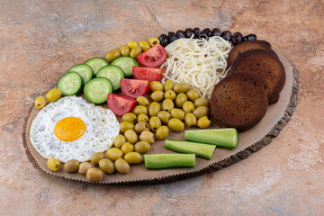 Breakfast board with bread slices, vegetable and egg