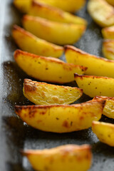 homemade potato wedges on a baking sheet