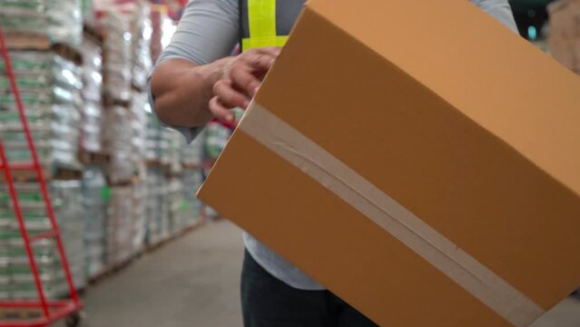 Worker stand in front of large warehouse store checking cardboard box for quality shipping, Caucasian staff holding sealed packing box finding empty box problem during logistic process.
