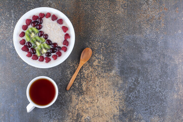 Muesli porridge with raspberries and a cup of drink
