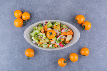 Vegetable salad with seasonal foods in a ceramic dish
