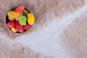 Multicolor dry cherries in a cup on concrete background