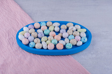 Pastel color stone candy balls on concrete background