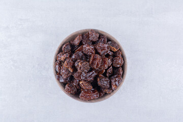 Dried sour cherries isolated in a plate on the background