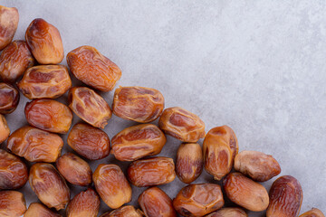 Brown dates isolated on concrete background
