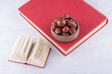 Dried plum cherries in a cup on concrete background