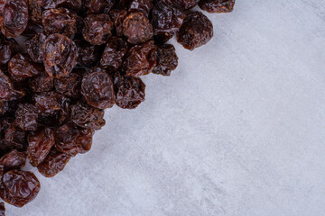 Dried sour cherries isolated on concrete background