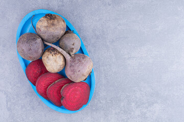 Beetroots isolated on the blue concrete background
