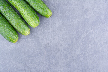 Green cucumber isolated on a concrete background
