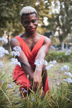 A young androgynous African boy posing in the middle of a park.LGTBI concept