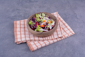 Fototapeta na wymiar Vegetable salad in a wooden platter with mixed ingredients
