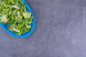 Green salad with herbs and spices in a ceramic plate