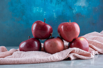 Red apples isolated on a pink tablecloth