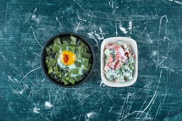 Green vegetable salad in a white ceramic plate