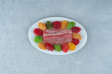 Colorful dry marmelade berries in a white plate