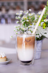 Aesthetic iced latte in the cafe. Guilty pleasure, coffee time. Vertical photo