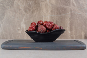 Dried indian jujube berries on a wooden platter