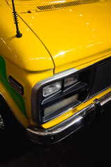 Fototapeta na wymiar Closeup photo of the front of a yellow car