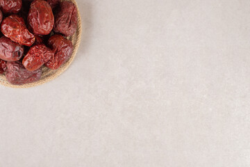 Dried jujube berries on a rustic wooden platter
