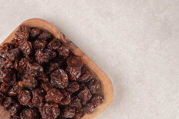 Fried brown sour cherries on a wooden platter