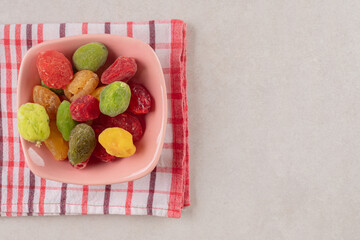 Colored apricots and cherries in a ceramic cup